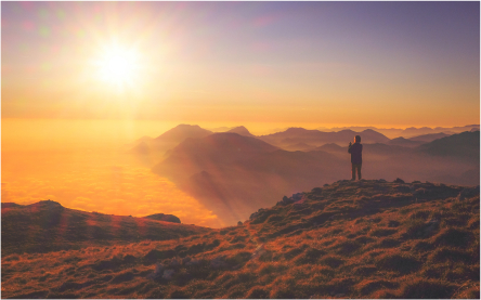 A sunset Image with a man watching it and enjoying